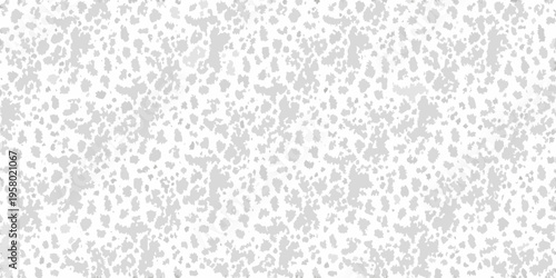 A grayscale speckled pattern resembling grainy texture or static noise