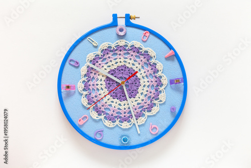 Time for crafting and crocheting. Handmade wall clock with knitting and sewing accessories instead of numbers and lace doily for embellished dial. Hobbies and relaxation through needlework