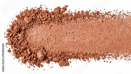 Crushed shimmery bronze powder spread on white background for makeup and beauty product design