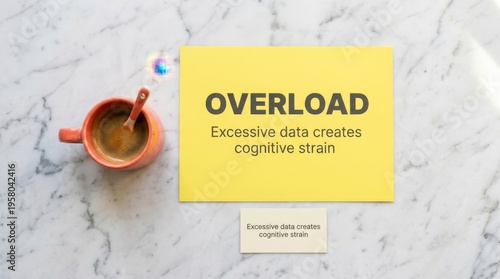 Overload: Excessive Data Creates Cognitive Strain Displayed on Yellow Card Next to Coffee