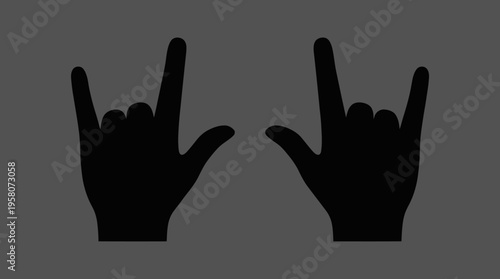 Two black silhouettes of hands making the rock and roll gesture against a dark grey background, symbolizing music and rebellion.