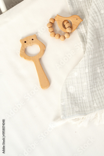 Wooden toys and a soft cloth on a light background in a nursery setting