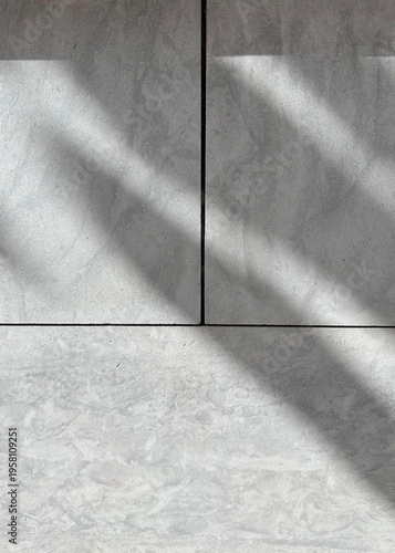 Two large, light gray concrete tiles, with diagonal shadows adding a sense of structure and depth. The clean lines and textures are great for a reel about design, modern architecture, or urban life.