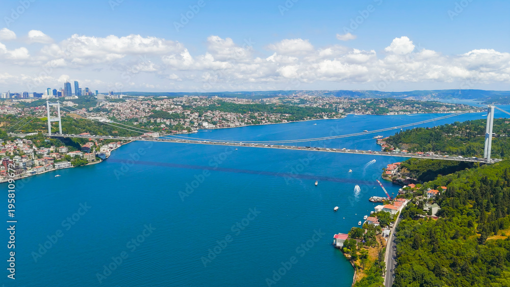 Fototapeta premium Istanbul, Turkey. Fatih Sultan Mehmet Bridge is a suspension bridge across the Bosphorus Strait, between Europe and Asia. Sunny day, Aerial View