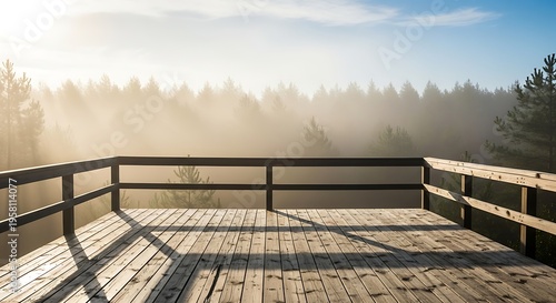 Wooden observation deck overlooking a misty forest at sunrise with sunbeams filtering through the trees