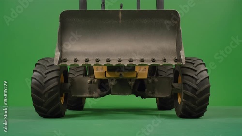 Wheel loader bucket lifting sequence on greenscreen background.