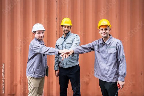 Engineer industrial workers males teamwork hands together at shipping container logistics site