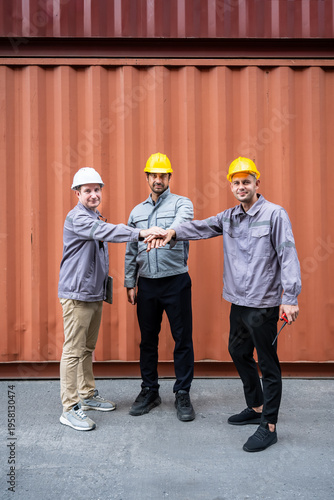 Engineer industrial workers males teamwork hands together in shipping container logistics warehouse