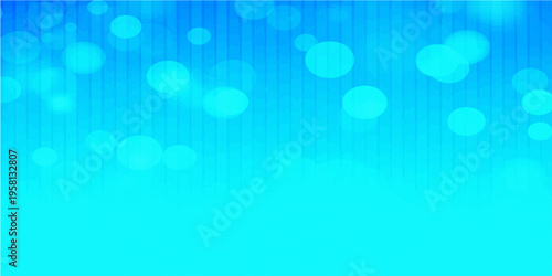 An abstract blue bokeh background featuring a bright, glowing design of shiny defocused circles and blurry light decorations for a festive Christmas wallpaper or vector backdrop