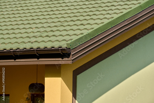 Roof line with brown gutters and wood soffit