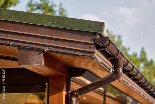 Roof line with brown gutters and wood soffit