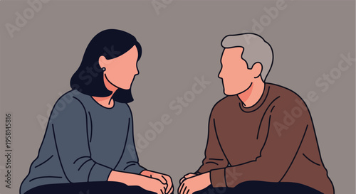 Two people, a woman and a man, sit facing each other on a plain background