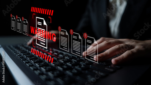 Quadro su tela A businessman focuses on his keyboard while warning symbols and documents appear, highlighting critical issues in cybersecurity and data protection in a modern digital workspace