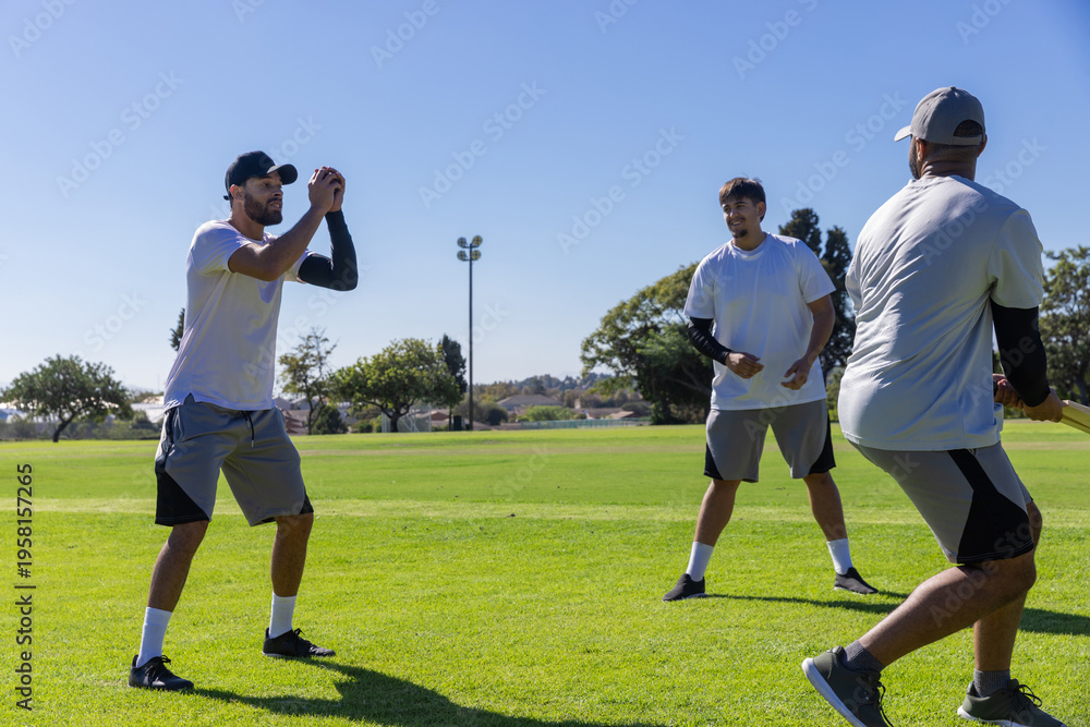 Obraz premium Three men wearing white tees practicing batting drill on local field with bat, copy space