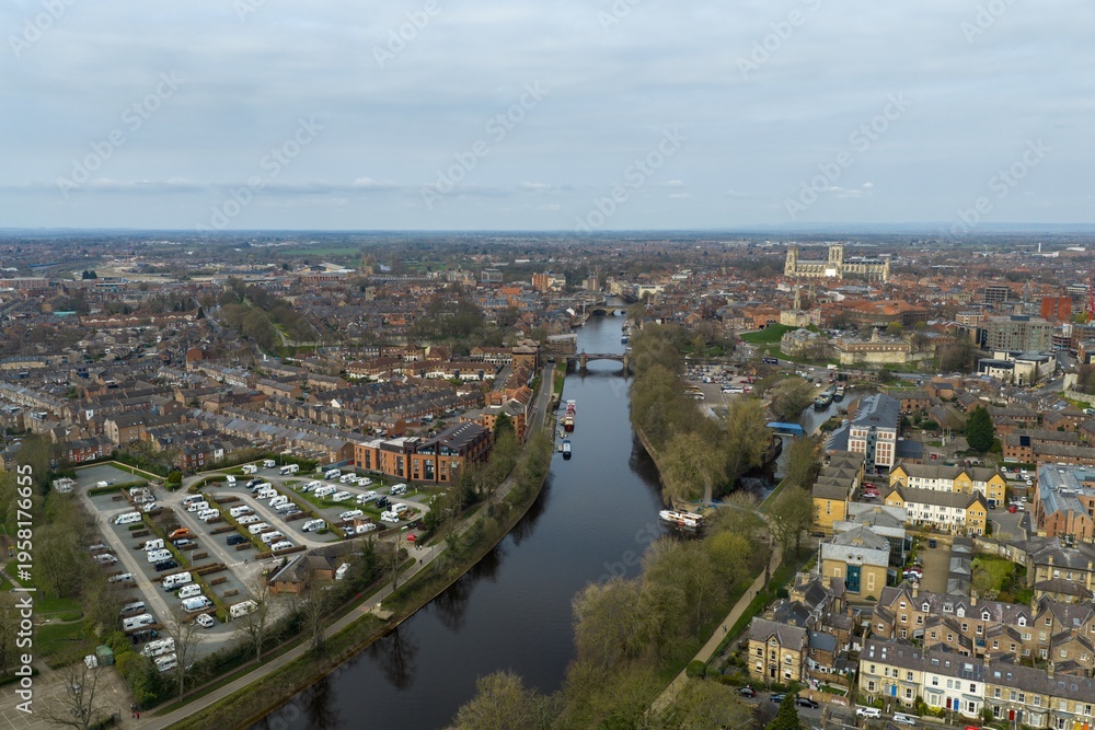 Obraz premium Aerial view photo of the city of York in the UK with River Ouse terraced housing caravan park and York Minster visible in the distance captured from above in early spring time