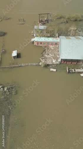 A spring large-scale flood disaster with fully submerged houses, flooded roads,and overflowing waterways. The footage shows the dramatic impact of heavy rainfall and rising water levels on residential