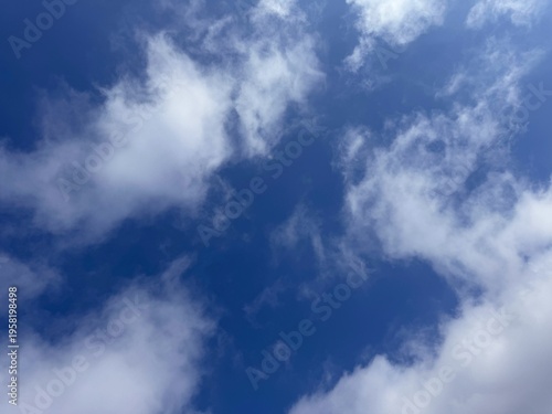 фотографія Blue sky with puffy white clouds.