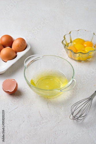Foto The process of separating eggs into whites and yolks on a white concrete background