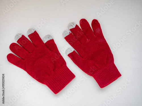 Top view of white cotton knitted gloves isolated on white