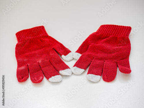 Top view of white cotton knitted gloves isolated on white
