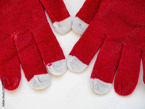 Top view of white cotton knitted gloves isolated on white