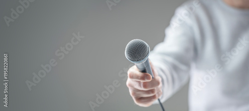 Reporter recording interview with microphone background