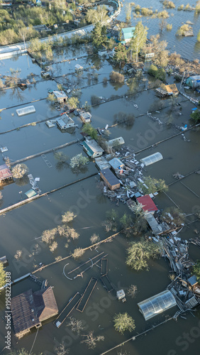 A spring large-scale flood disaster with fully submerged houses, flooded roads,and overflowing waterways. The footage shows the dramatic impact of heavy rainfall and rising water levels on residential