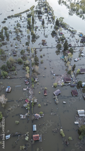 A spring large-scale flood disaster with fully submerged houses, flooded roads,and overflowing waterways. The footage shows the dramatic impact of heavy rainfall and rising water levels on residential