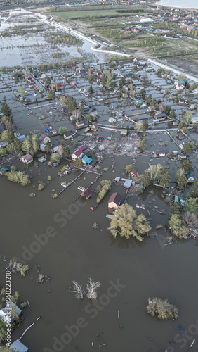 A spring large-scale flood disaster with fully submerged houses, flooded roads,and overflowing waterways. The footage shows the dramatic impact of heavy rainfall and rising water levels on residential