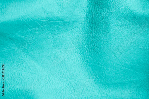 фотографія Vibrant turquoise colored textured leather fabric surface background displaying