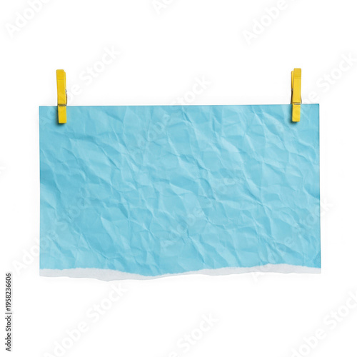 A light blue paper hanging from two yellow clothespins on a string