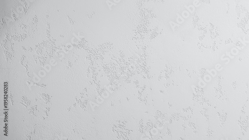 White textured wall surface displaying a granular rough concrete pattern ideal for background designs