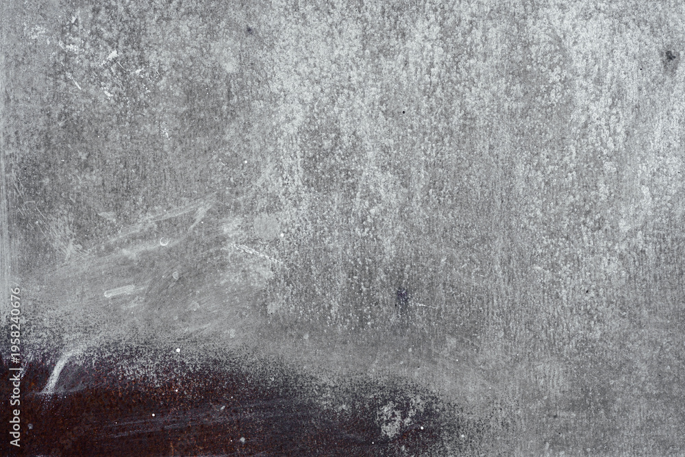 Obraz premium Rough gray stone surface with dark brown stain and white streaks.