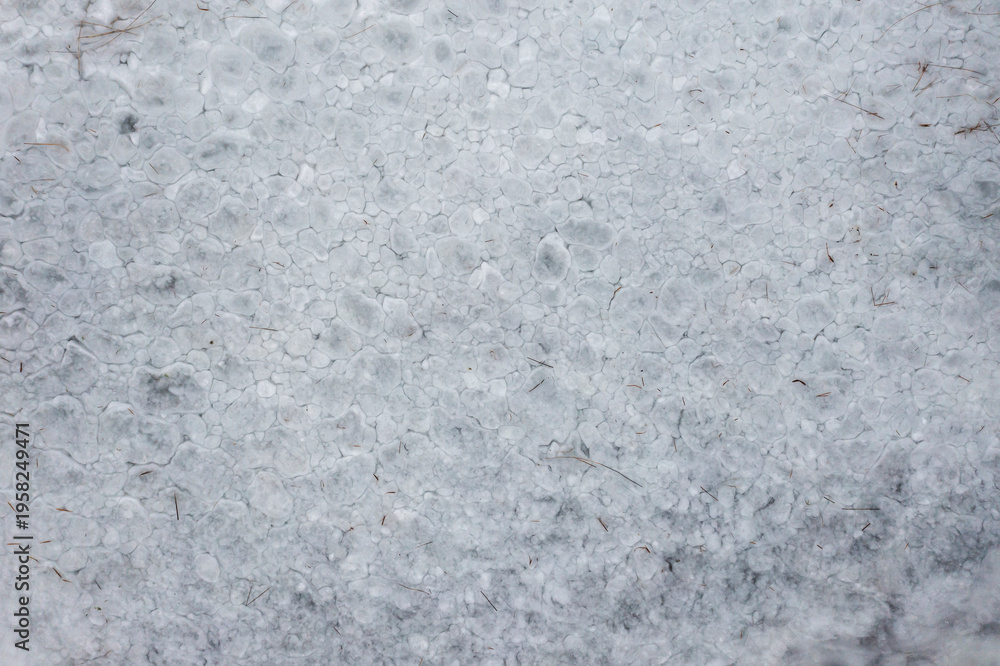 Fototapeta premium Texture of a frozen lake of ice, top view from a drone.
