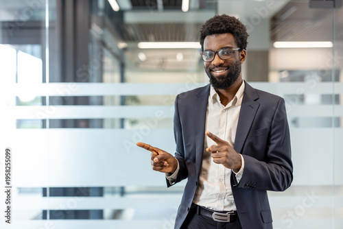 Photos Professional businessman in a modern office wearing glasses and a suit, smiling