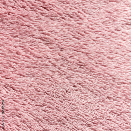 Soft pink faux fur texture, fluffy plush fabric background with long pile for cozy winter designs