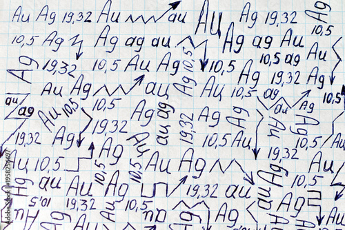 Drawing with a pen on a sheet of a school notebook of signs and symbols of precious metals.