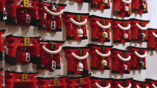 Traditional Japanese tourist souvenirs and gifts from Kyoto, Kansai, Japan, with daruma figures, kitsune fox, tengu mask, fridge magnets, toys figurines, key ring keychain, in a local vendor gift shop