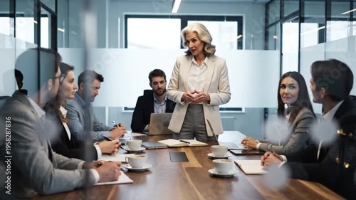 Experienced senior businesswoman effectively leads a diverse corporate team during a productive board meeting, fostering collaboration and strategic discussion in a modern office environment