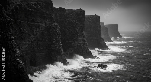 Dramatic Black and White Cliffs: Coastal Waves Crashing Against Rugged Rocks