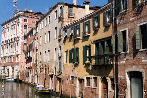 Typical view of a Venetian canal with historic buildings. Beautiful Venetian tenement houses along the canal in Venice, Italy