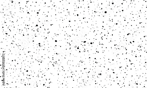 Sparse black ink splatter and small paint drops on white background for artistic design element