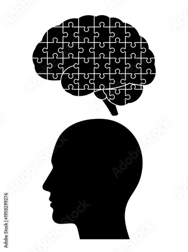 Brain puzzle concept represented above a silhouette of a person's head, symbolizing intellect and the mind. It is a creative concept illustrating the human brain in the form of a jigsaw puzzle