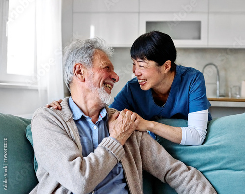 Doctor or nurse caregiver with senior man talking and having fun at home or nursing home