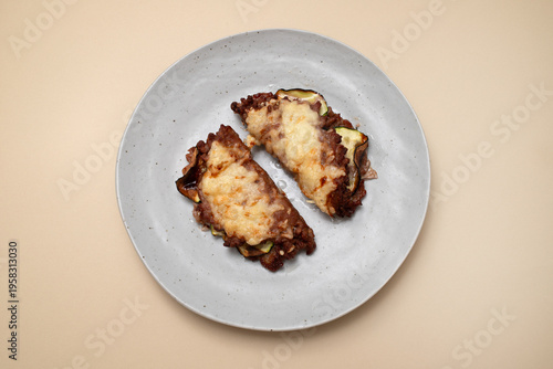 Fried ground meat with cheese and vegetables on plate