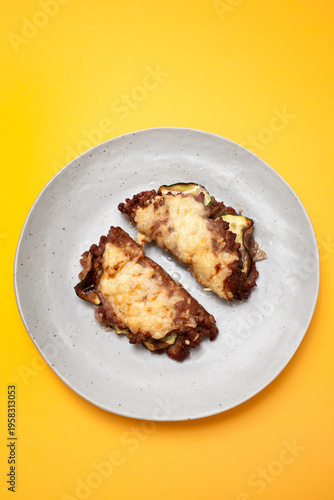 Fried ground meat with cheese and vegetables on plate