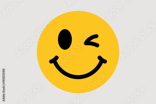 A vibrant yellow winking smiley face icon featuring a bold black graphical character expressing happiness and playfulness on a clean minimalist light grey background representing positive communicatio