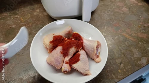 preparing chicken drumstick in white plate