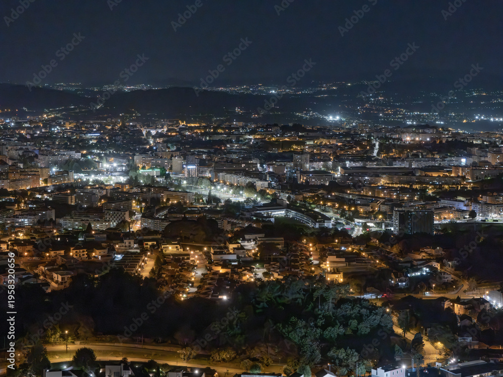 Fototapeta premium Night aerial view of Braga city lights and urban architecture, Minho region, Portugal