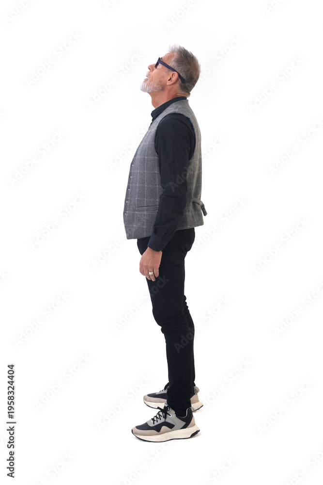 Fototapeta premium side view of a modern retired man standing looking up on white background
